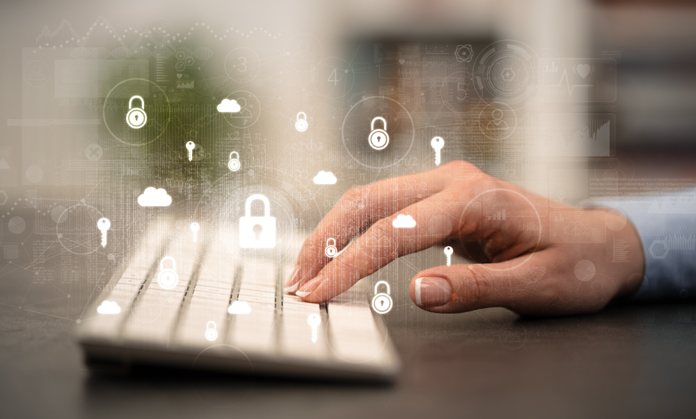 Woman hand typing on keyboard with secured lock concept around