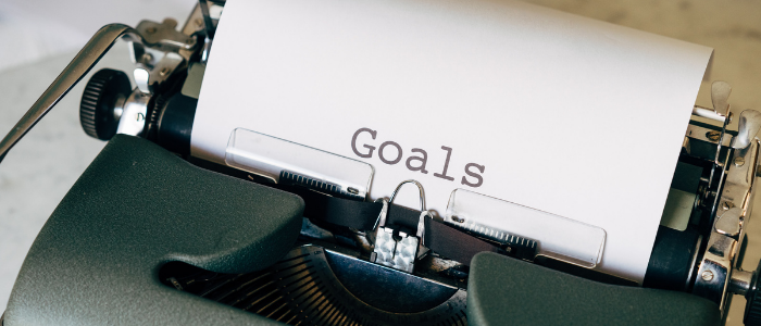 Dactylo avec le mot goals pour illustrer l'importance de comprendre les objectifs des clients